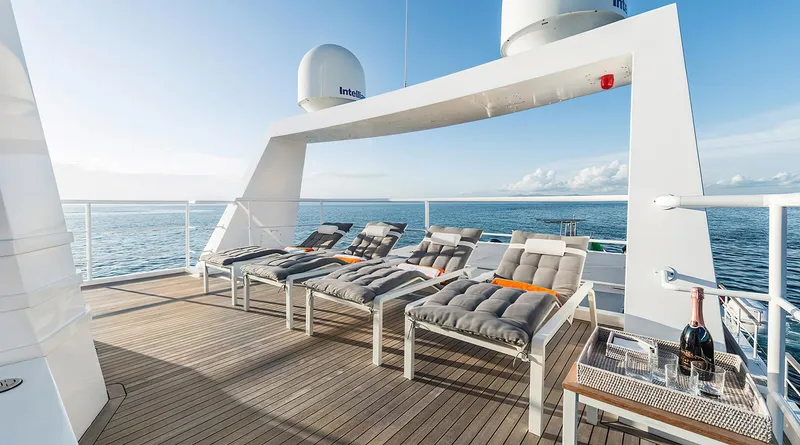 Explorer 130 Yacht Photos Pics Luxurious deck of Ocean King Explorer 130 yacht, 2027, with sun loungers and ocean view.