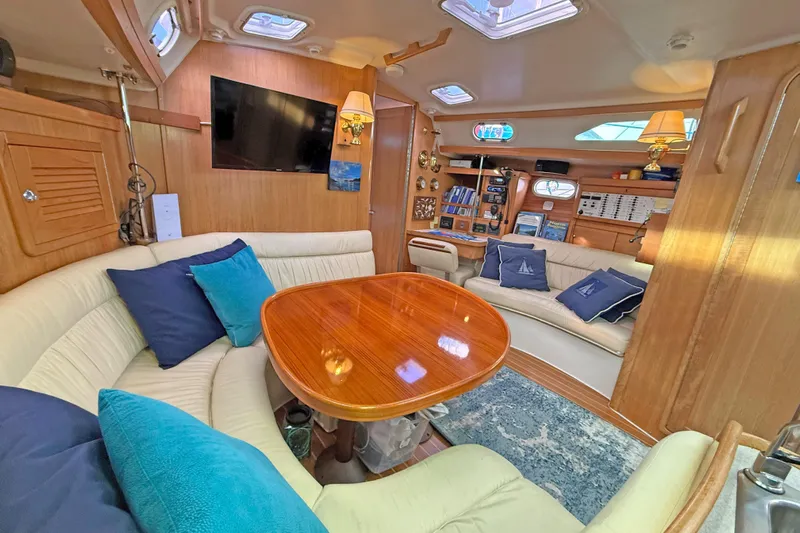 Shumka Yacht Photos Pics Luxurious interior of a 2005 Catalina 42 MkII yacht with plush seating and elegant wood finishes.