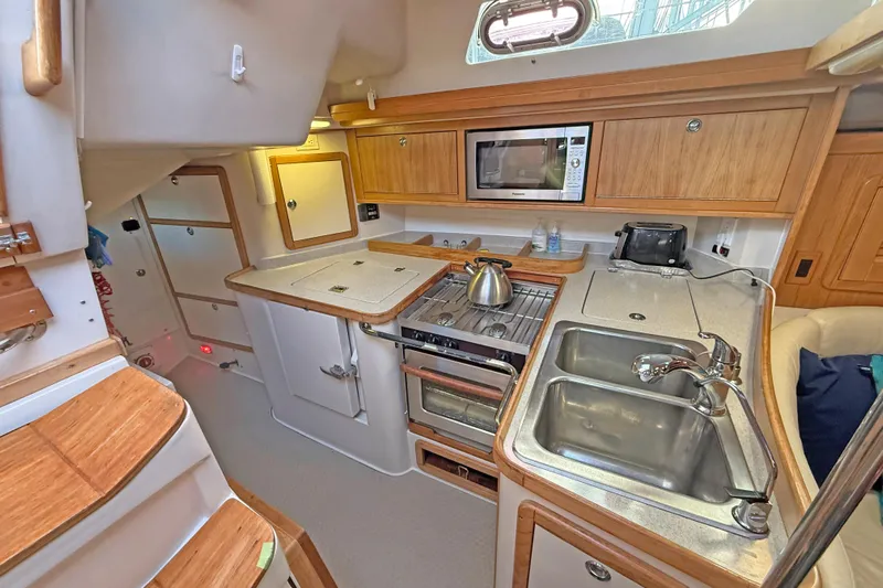 Shumka Yacht Photos Pics 2005 Catalina 42 MkII yacht kitchen with stove, sink, and microwave.