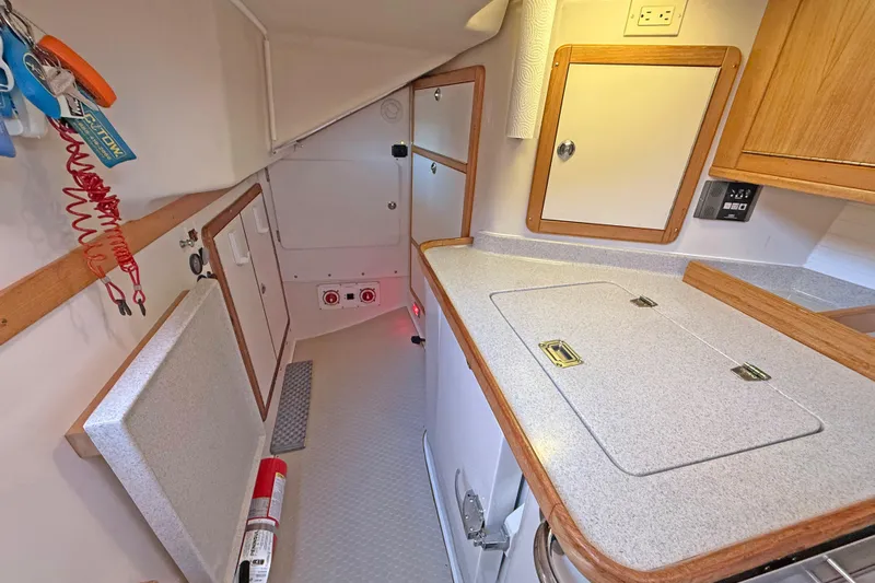 Shumka Yacht Photos Pics 2005 Catalina 42 MkII yacht interior with compact kitchen and storage cabinets.