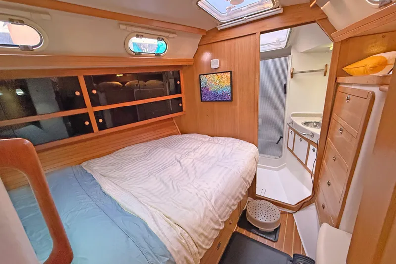 Shumka Yacht Photos Pics Cozy cabin interior of 2005 Catalina 42 MkII sailboat with bed and ensuite bathroom.