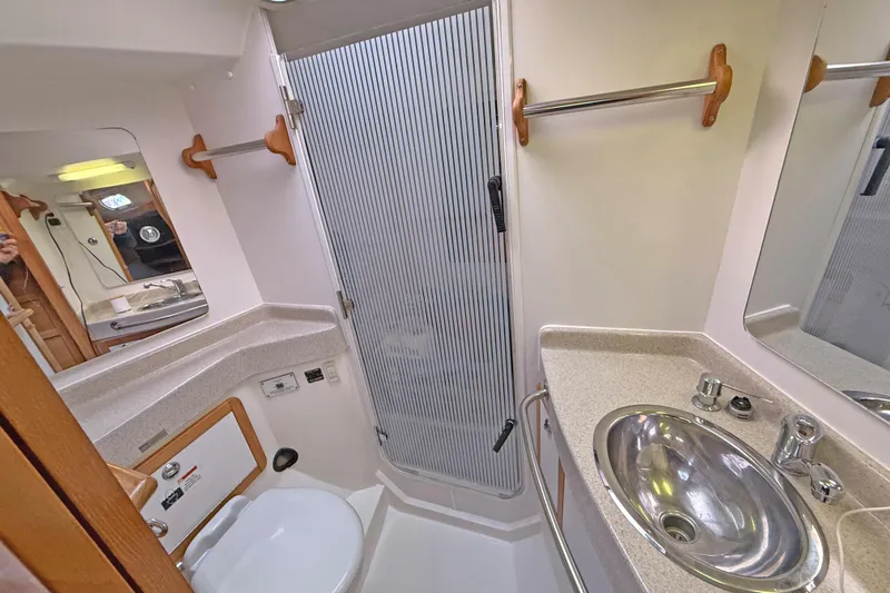 Shumka Yacht Photos Pics Bathroom interior of 2005 Catalina 42 MkII yacht, featuring sink, toilet, and shower.