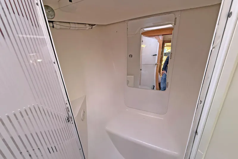 Shumka Yacht Photos Pics Bathroom interior of 2005 Catalina 42 MkII sailboat, featuring a mirror and shower area.