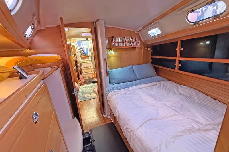 Shumka Yacht Photos Pics Cozy cabin interior of 2005 Catalina 42 MkII sailboat with bed and wooden furnishings.