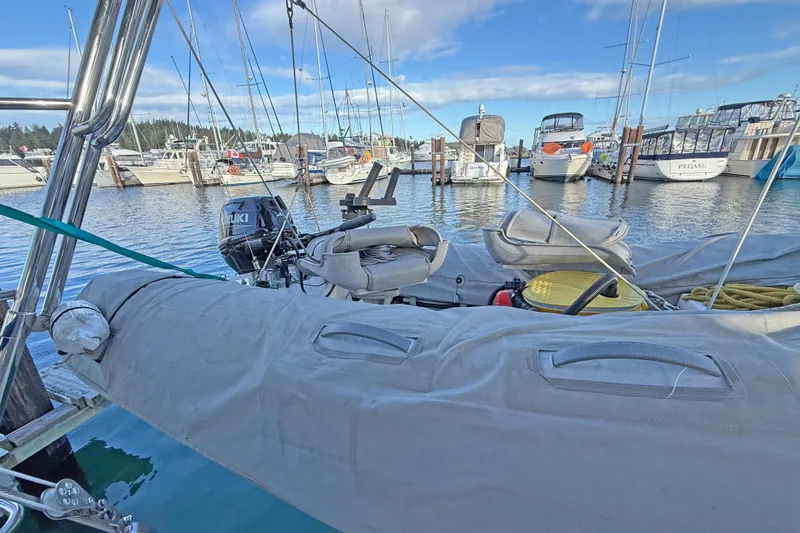 Shumka Yacht Photos Pics Catalina 42 MkII sailboat docked at marina, featuring inflatable dinghy and Suzuki outboard motor.