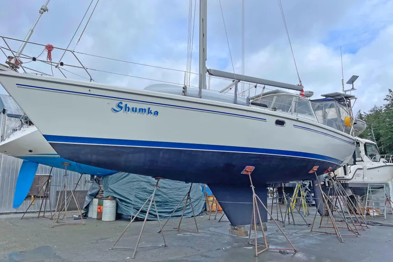 Shumka Yacht Photos Pics 2005 Catalina 42 MkII sailboat on stands, named "Shumka," in a boatyard.