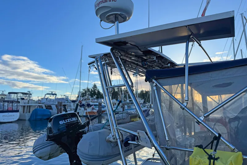 Shumka Yacht Photos Pics Catalina 42 MkII sailboat, 2005 model, docked with Suzuki outboard motor, sunny marina background.