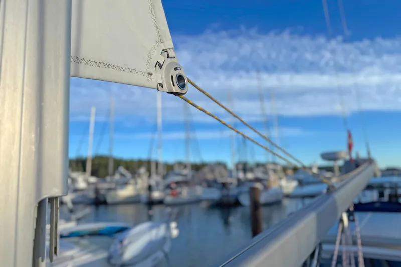 Shumka Yacht Photos Pics Close-up of a 2005 Catalina 42 MkII sailboat mast in a marina setting.