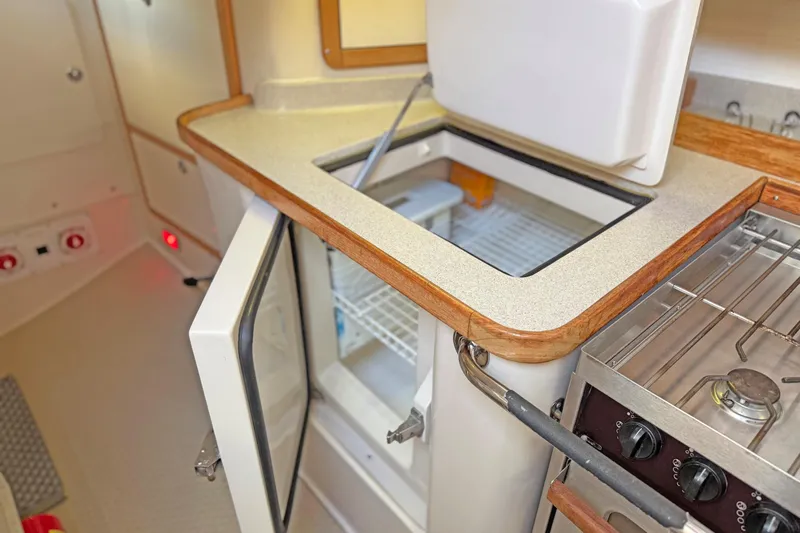 Shumka Yacht Photos Pics 2005 Catalina 42 MkII yacht kitchen with open fridge and stove.