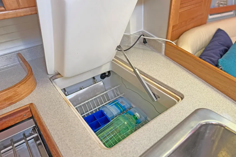 Shumka Yacht Photos Pics 2005 Catalina 42 MkII yacht galley with open fridge, showcasing storage and design.