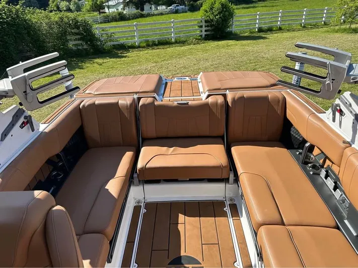  Yacht Photos Pics 2023 Malibu Wakesetter 23 MXZ interior with tan leather seating and open-air design.