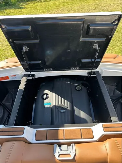  Yacht Photos Pics 2023 Malibu Wakesetter 23 MXZ engine compartment with open hatch, showcasing engine details.