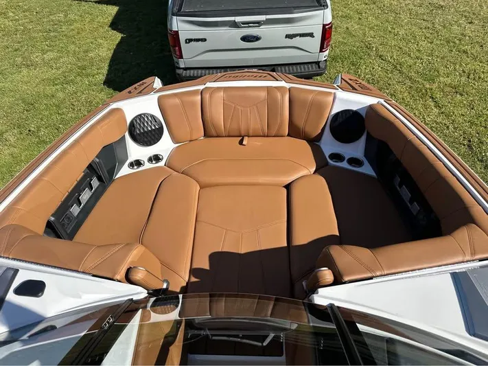  Yacht Photos Pics 2023 Malibu Wakesetter 23 MXZ boat with tan leather seating and cup holders.