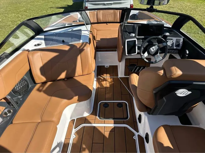  Yacht Photos Pics 2023 Malibu Wakesetter 23 MXZ interior with tan leather seats and modern dashboard.