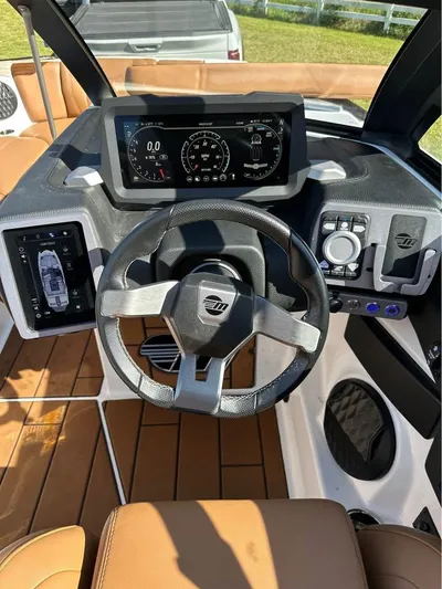  Yacht Photos Pics 2023 Malibu Wakesetter 23 MXZ dashboard with steering wheel and digital display.