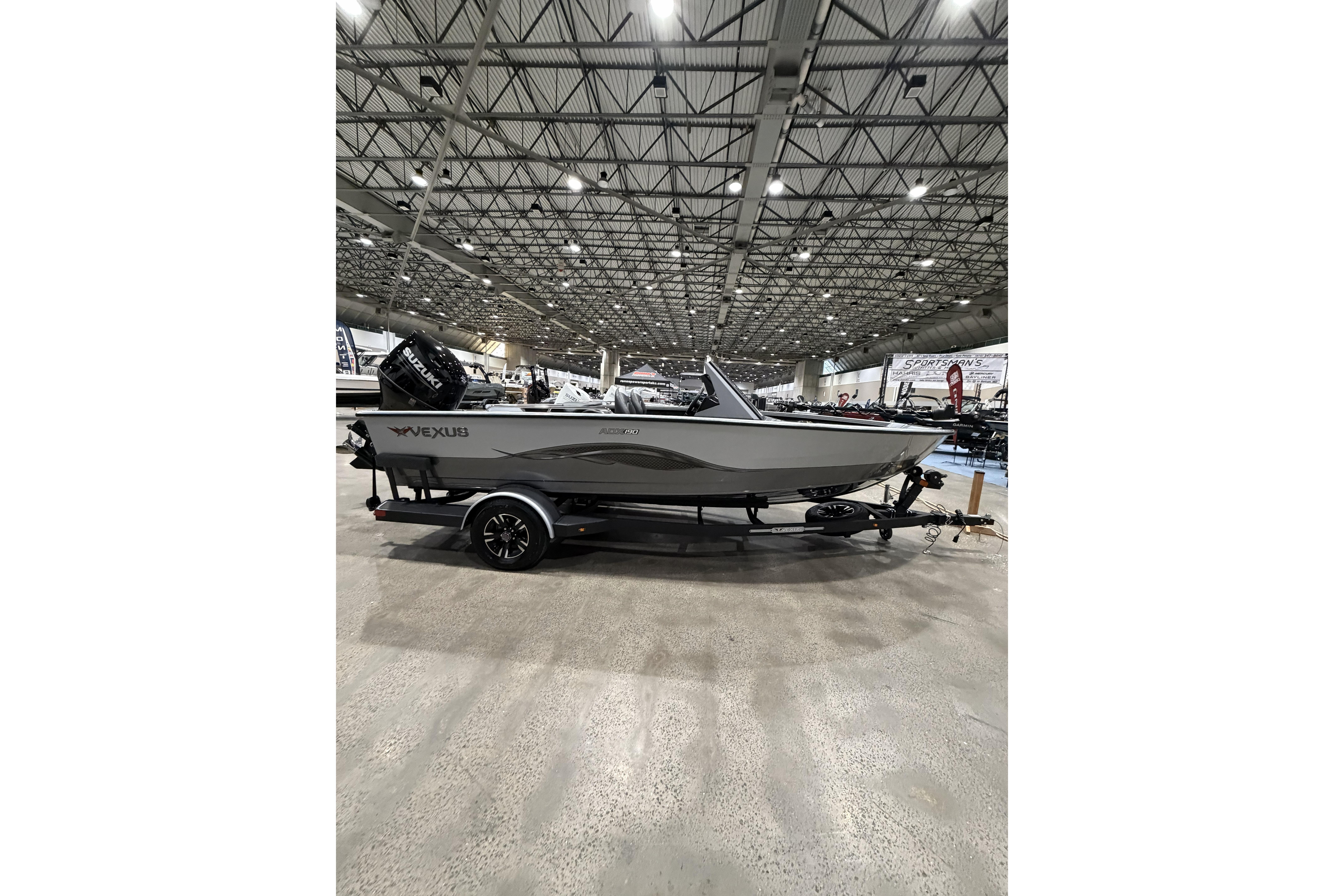 2026 Vexus ADX 190 boat on display in a large indoor showroom.