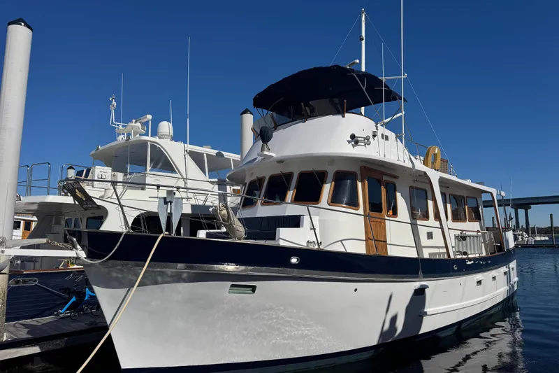 Savasa Yacht Photos Pics 1979 Cheoy Lee 46 LRC yacht docked at marina under clear blue sky.