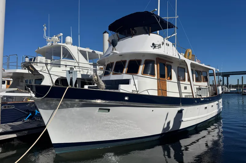 Savasa Yacht Photos Pics 1979 Cheoy Lee 46 LRC yacht docked at marina under clear blue sky.