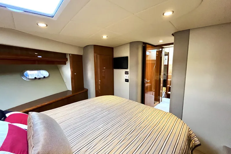 Yacht-o-fun Yacht Photos Pics Luxurious bedroom interior of 2014 Riviera 5800 Sport Yacht with modern amenities.