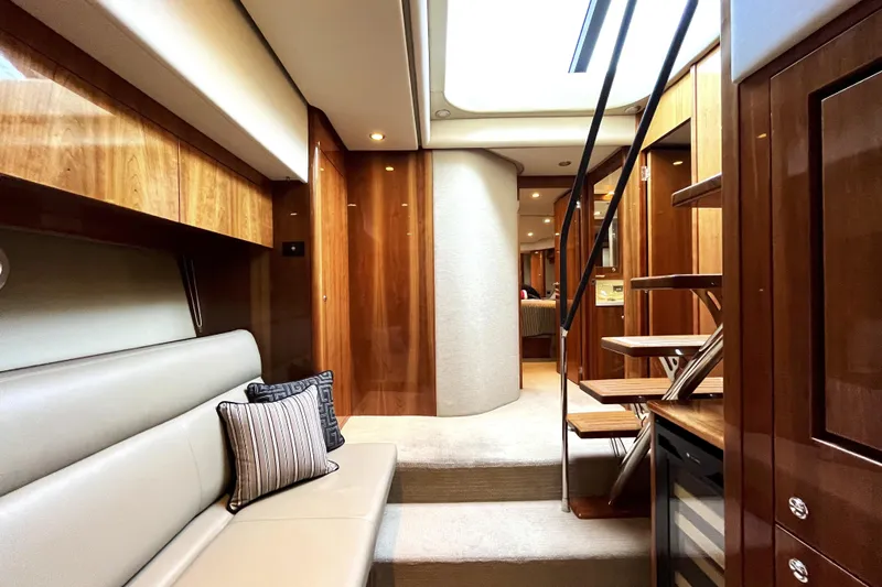 Yacht-o-fun Yacht Photos Pics Luxurious interior of 2014 Riviera 5800 Sport Yacht with elegant wood finishes and modern design.