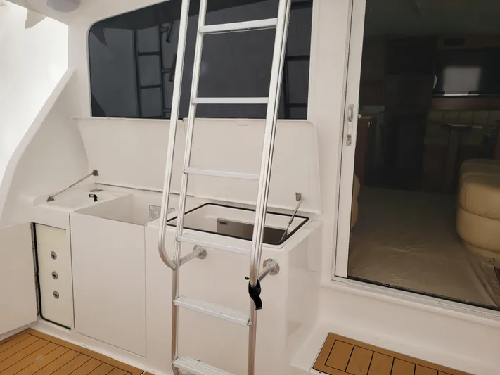  Yacht Photos Pics 1986 Ocean Yachts 55 Super Sport yacht interior with ladder and storage compartments.