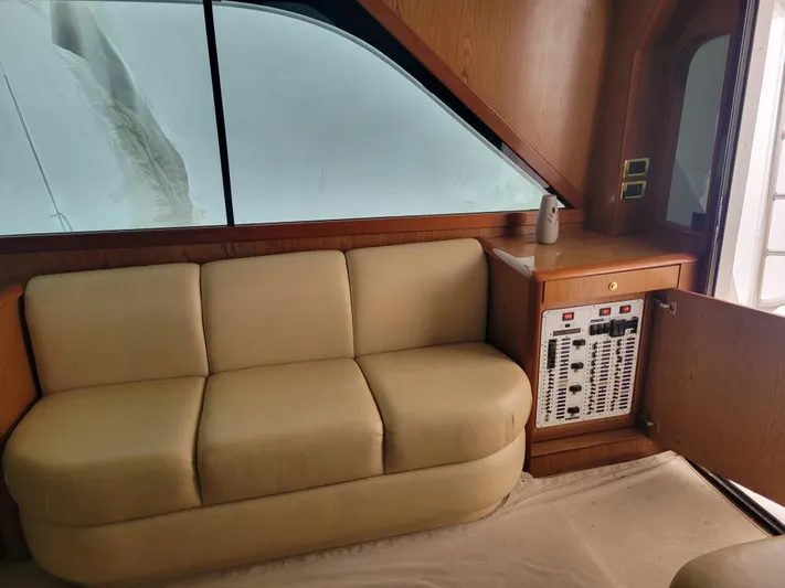  Yacht Photos Pics Interior of 1986 Ocean Yachts 55 Super Sport with beige sofa and control panel.