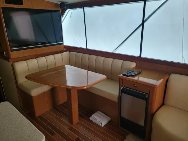  Yacht Photos Pics Interior of 1986 Ocean Yachts 55 Super Sport with dining area and TV.