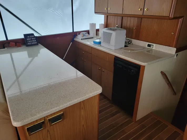 Yacht Photos Pics 1986 Ocean Yachts 55 Super Sport kitchen with countertops and wooden cabinets.
