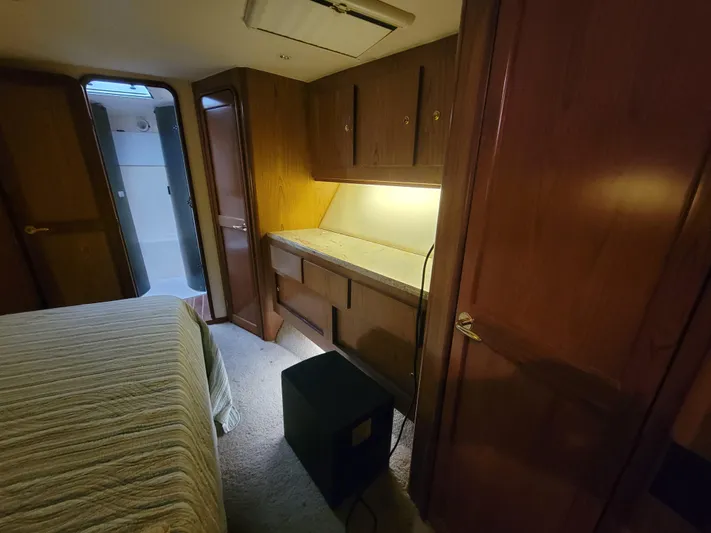  Yacht Photos Pics 1986 Ocean Yachts 55 Super Sport bedroom with wooden cabinetry and ensuite bathroom.