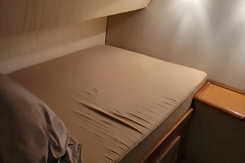  Yacht Photos Pics Cozy bedroom in 1986 Ocean Yachts 55 Super Sport with soft lighting.