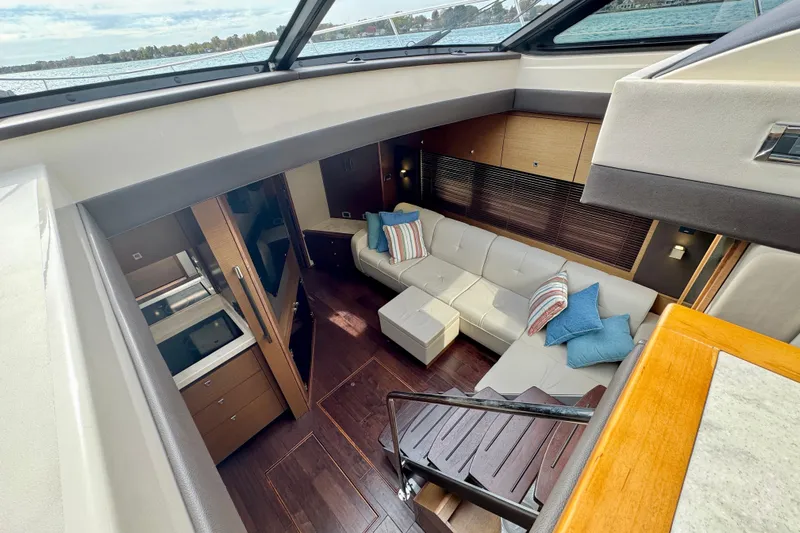 Floor It Yacht Photos Pics Luxurious interior of 2014 Sea Ray 510 Sundancer yacht with modern furnishings and large windows.