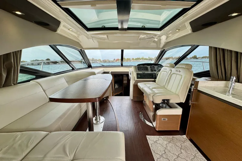 Floor It Yacht Photos Pics Luxurious interior of 2014 Sea Ray 510 Sundancer yacht with leather seating and panoramic windows.