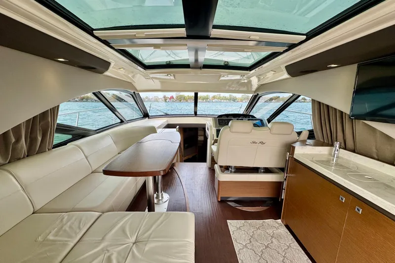Floor It Yacht Photos Pics Luxurious interior of 2014 Sea Ray 510 Sundancer yacht with leather seating and panoramic windows.