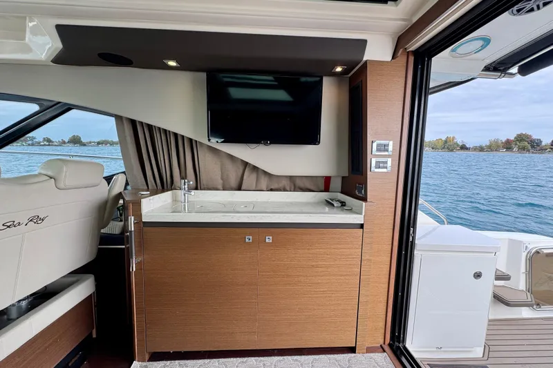 Floor It Yacht Photos Pics Luxurious interior of 2014 Sea Ray 510 Sundancer yacht with kitchenette and water view.