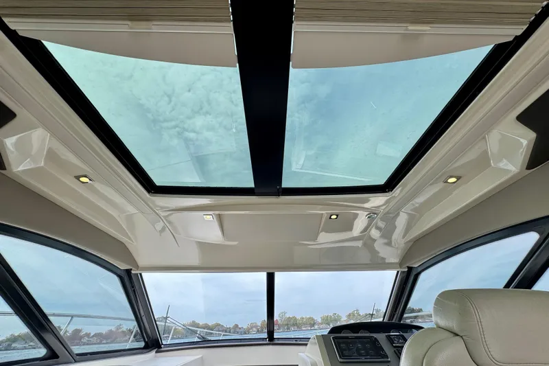 Floor It Yacht Photos Pics Interior view of 2014 Sea Ray 510 Sundancer with panoramic sunroof and modern design.