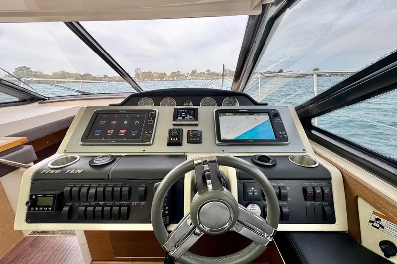 Floor It Yacht Photos Pics 2014 Sea Ray 510 Sundancer helm with advanced navigation systems and steering wheel.