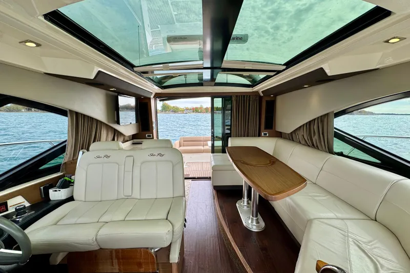 Floor It Yacht Photos Pics Luxurious interior of 2014 Sea Ray 510 Sundancer yacht with panoramic windows and elegant seating.