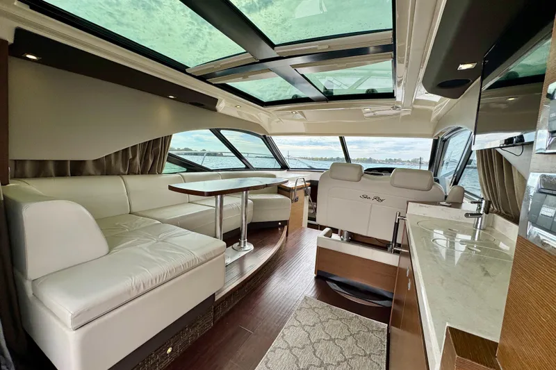 Floor It Yacht Photos Pics Luxurious interior of 2014 Sea Ray 510 Sundancer yacht with panoramic windows and elegant seating.