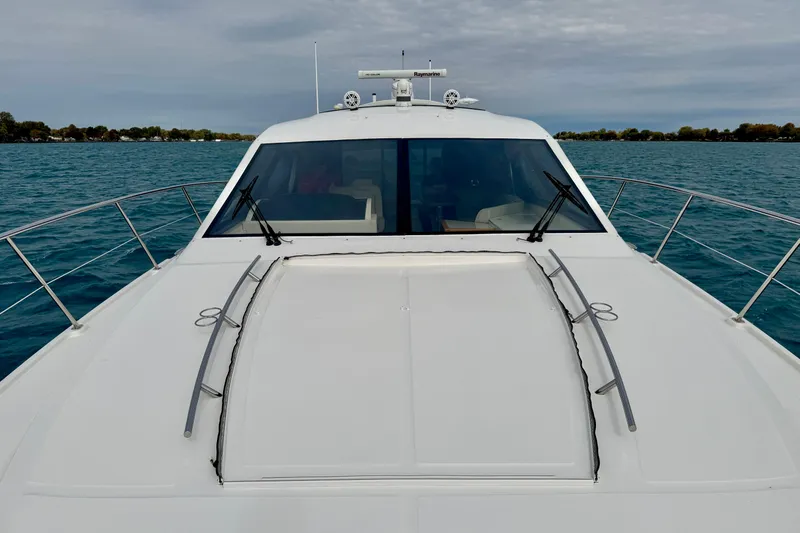 Floor It Yacht Photos Pics 2014 Sea Ray 510 Sundancer yacht on calm blue water under cloudy sky.