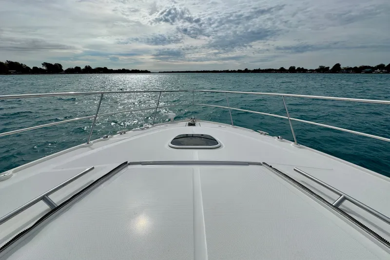 Floor It Yacht Photos Pics Bow view of 2014 Sea Ray 510 Sundancer on open water under cloudy sky.
