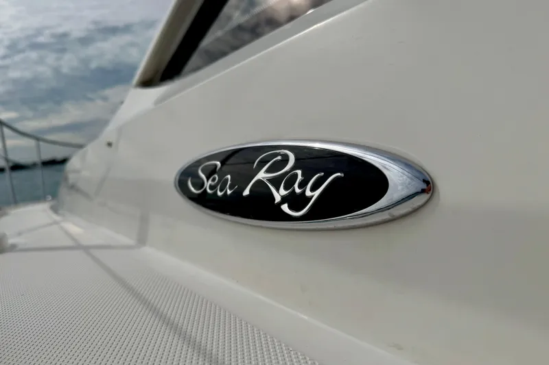 Floor It Yacht Photos Pics 2014 Sea Ray 510 Sundancer yacht emblem on sleek white exterior.