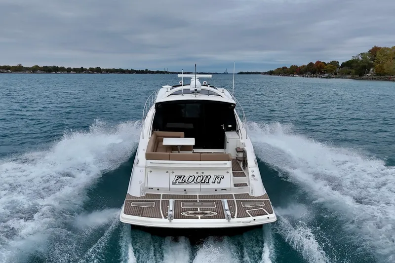 Floor It Yacht Photos Pics 2014 Sea Ray 510 Sundancer cruising on open water, rear view.