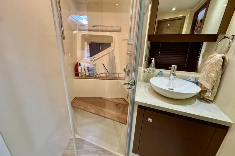 Floor It Yacht Photos Pics Luxurious bathroom in 2014 Sea Ray 510 Sundancer yacht with modern fixtures and wooden accents.