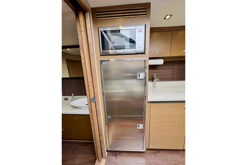 Floor It Yacht Photos Pics Modern kitchen area in 2014 Sea Ray 510 Sundancer yacht with stainless steel appliances.