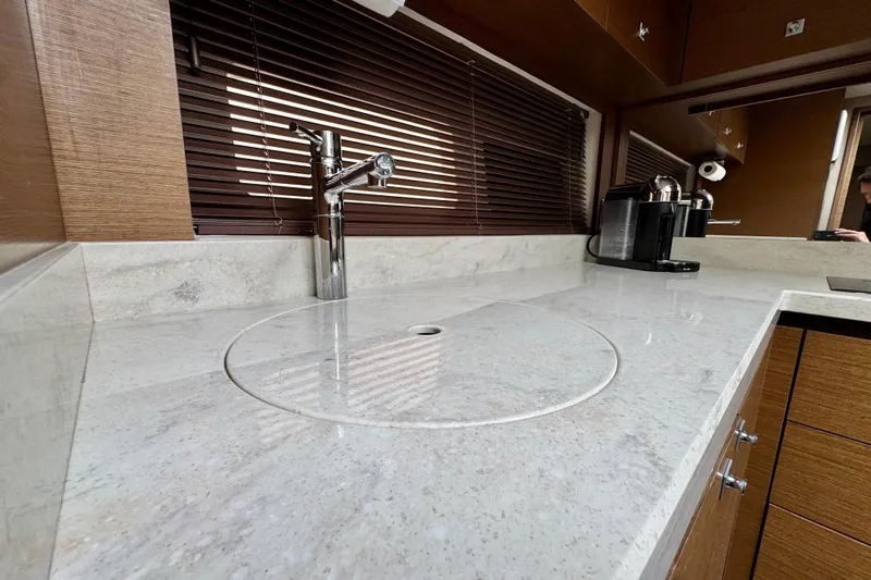 Floor It Yacht Photos Pics Luxurious kitchen countertop in 2014 Sea Ray 510 Sundancer yacht, featuring sleek faucet and coffee maker.