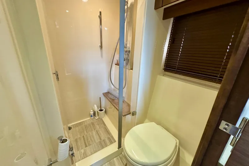 Floor It Yacht Photos Pics Bathroom interior of 2014 Sea Ray 510 Sundancer yacht, featuring shower and toilet.