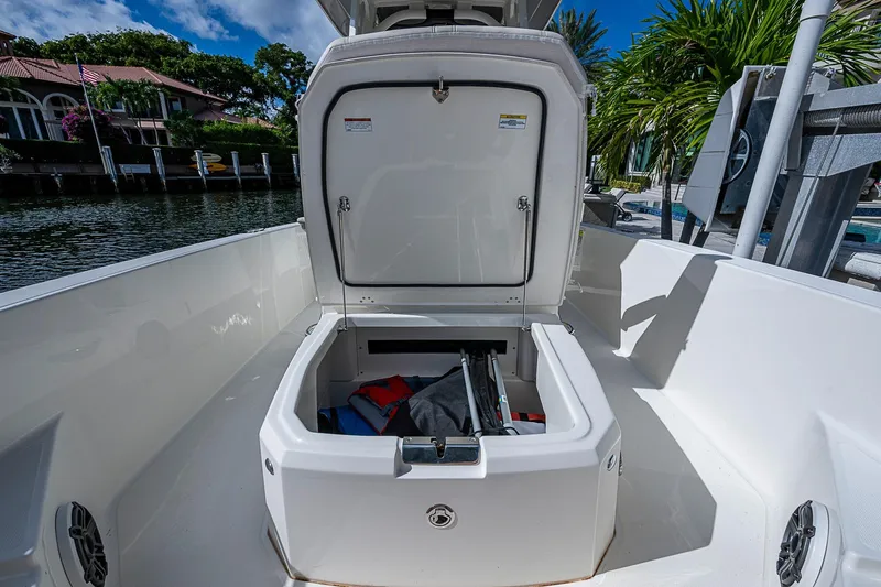  Yacht Photos Pics 2023 Boston Whaler 250 Dauntless boat with open storage compartment, dockside view.