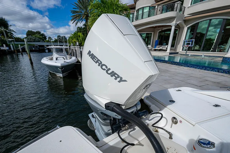  Yacht Photos Pics 2023 Boston Whaler 250 Dauntless with Mercury engine docked by luxury waterfront home.