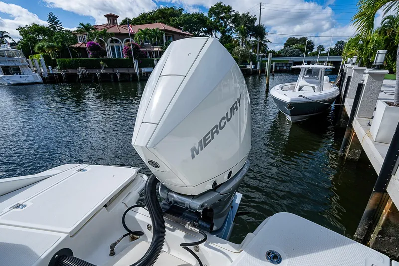  Yacht Photos Pics 2023 Boston Whaler 250 Dauntless with Mercury engine docked by waterfront homes.