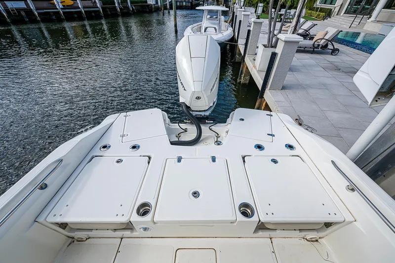  Yacht Photos Pics 2023 Boston Whaler 250 Dauntless boat docked, showcasing spacious deck and modern design.